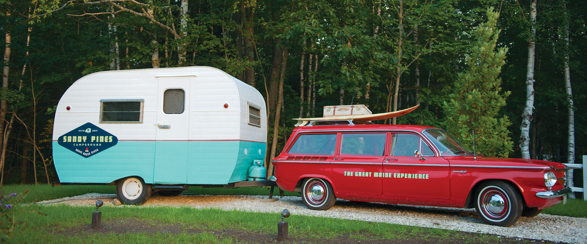 Vintage car and vintage camper at entrance of Sandy Pines Campground