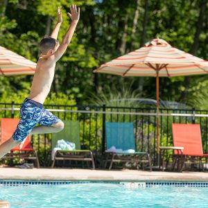kid jumping into Sandy Pines Pool