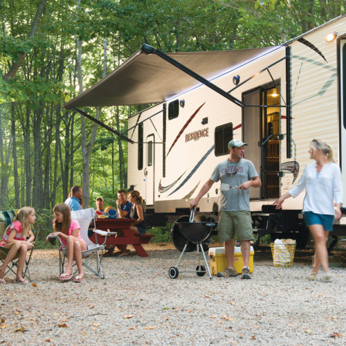 rv campsite with families in front of it.